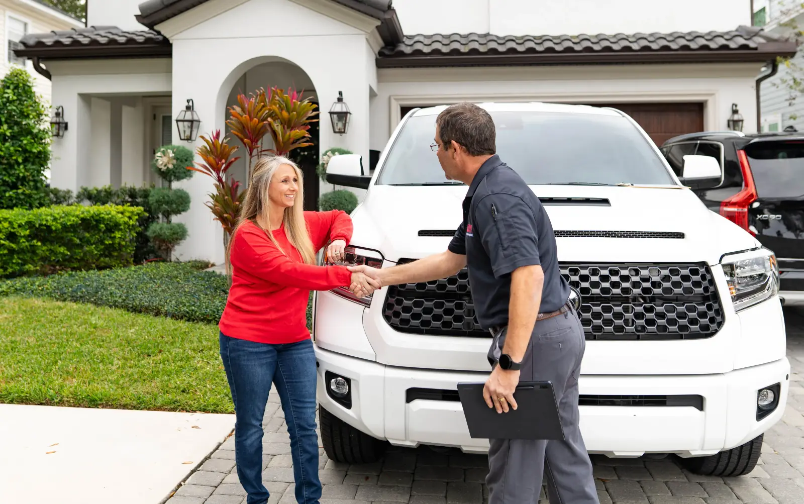 Liberty Pest Management technician inspecting a home's exterior